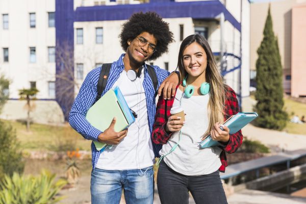 happy-mixed-race-couple-posing-front-university-building-1-scaled